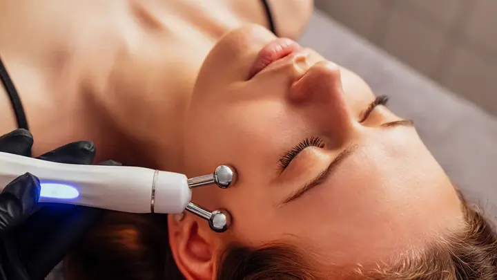 a woman getting a professional microcurrent treatment